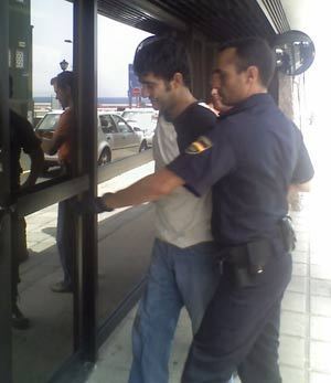 Darli Velazquez picture escorted by Spanish Police after being taken into custody.